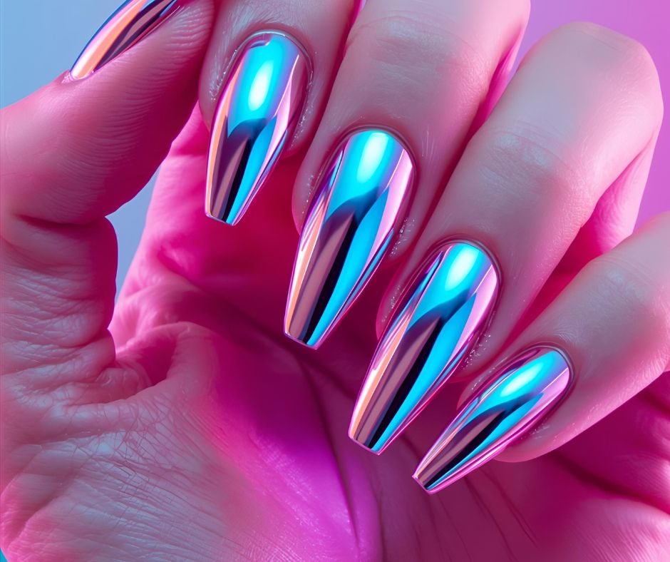 Hand with silver chrome nail polish on a pink background
