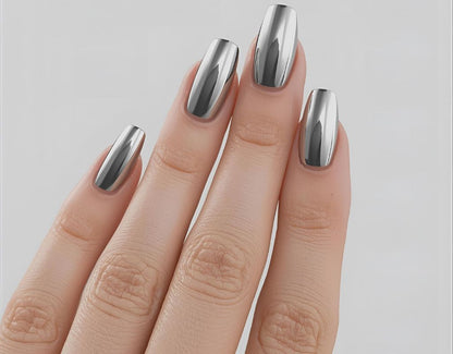 Hand with metallic silver nail polish on a light gray background